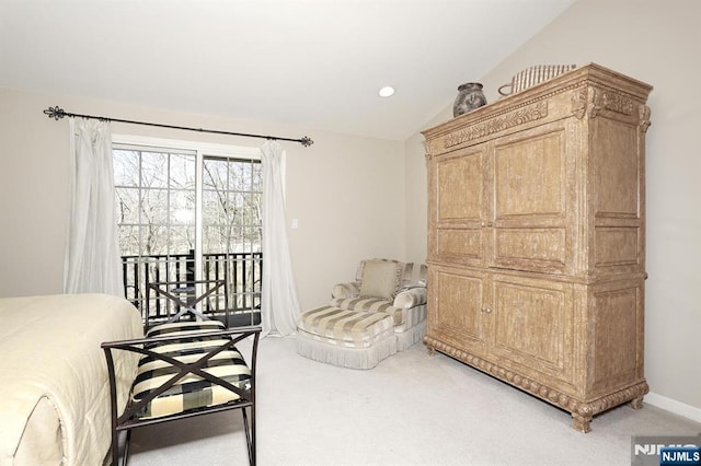 sitting room with carpet flooring, vaulted ceiling, and baseboards