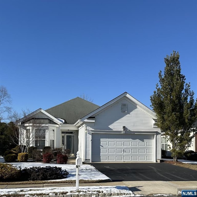 ranch-style house featuring driveway and an attached garage