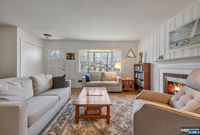 living area featuring a brick fireplace and wood finished floors