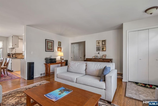 living room with light wood-type flooring and visible vents