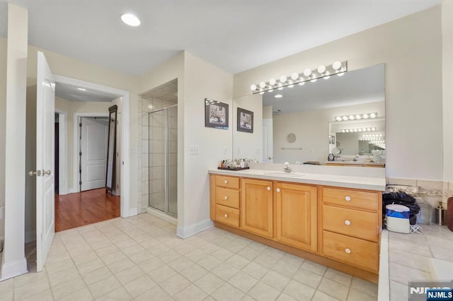 full bathroom with a stall shower, tile patterned flooring, and vanity