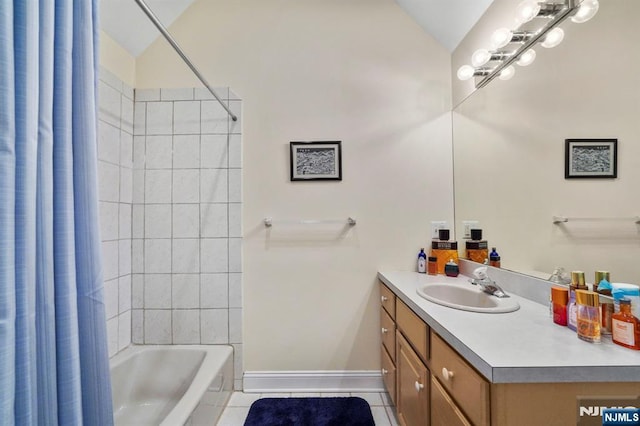 bathroom with shower / tub combo with curtain, lofted ceiling, vanity, tile patterned flooring, and baseboards