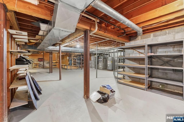 unfinished basement featuring water heater