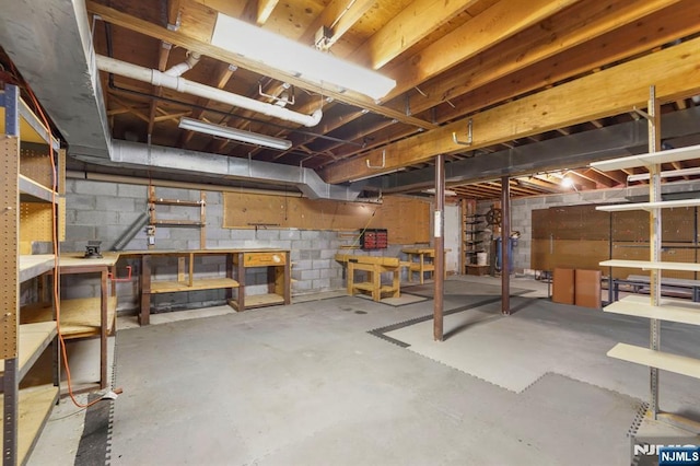 unfinished basement featuring a workshop area