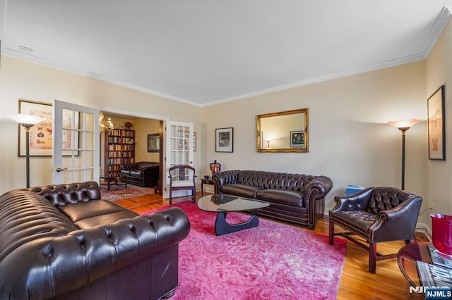 living room featuring ornamental molding, wood finished floors, and french doors