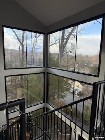 sunroom / solarium featuring lofted ceiling and a healthy amount of sunlight