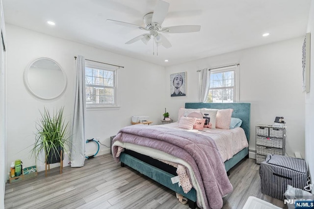 bedroom featuring light wood-style floors, recessed lighting, and multiple windows