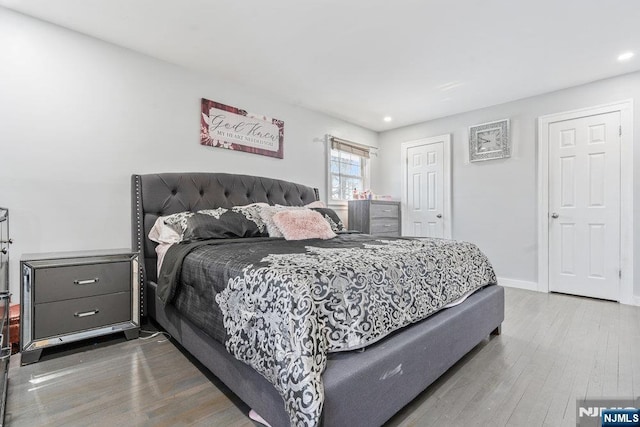 bedroom featuring a closet, baseboards, and wood finished floors