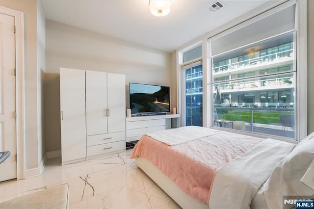 bedroom with visible vents, marble finish floor, baseboards, and expansive windows