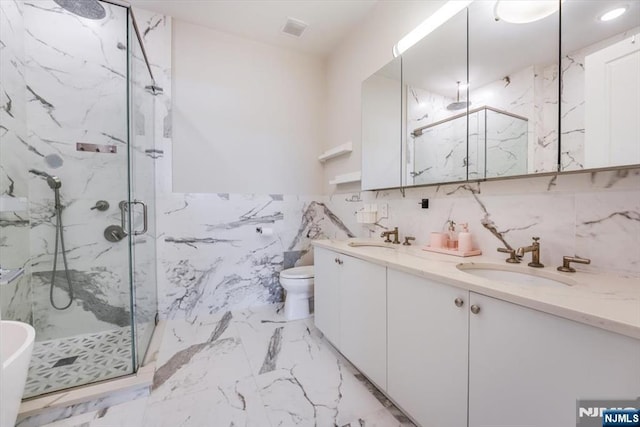 full bathroom with a sink, a marble finish shower, and marble finish floor