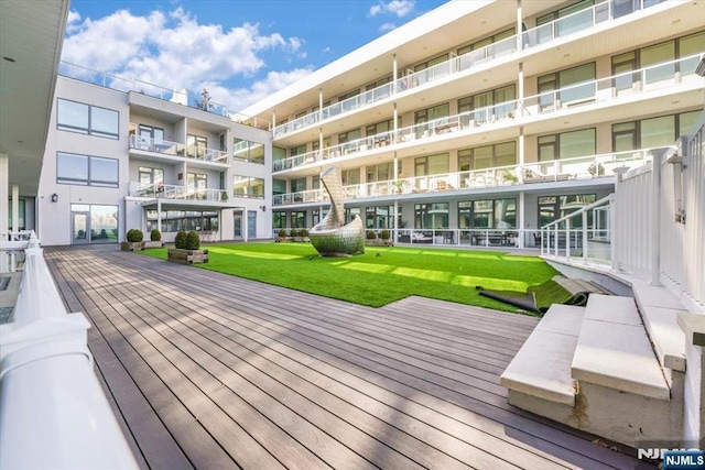 wooden terrace with a lawn