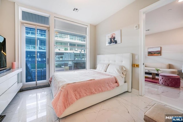 bedroom with visible vents, marble finish floor, a wall of windows, baseboards, and access to exterior