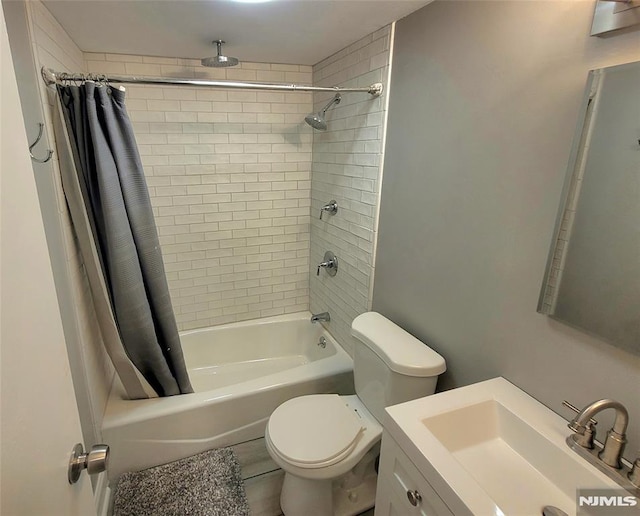 bathroom featuring shower / bath combination with curtain, vanity, and toilet