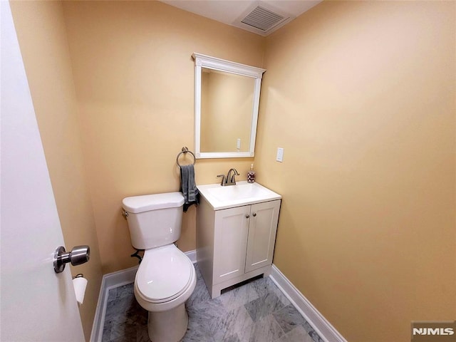 bathroom with baseboards, visible vents, toilet, marble finish floor, and vanity