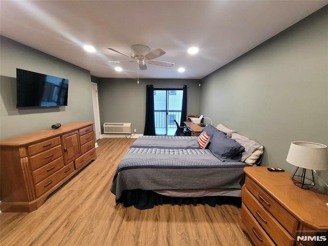 bedroom featuring a wall mounted AC, recessed lighting, light wood-style flooring, and a ceiling fan