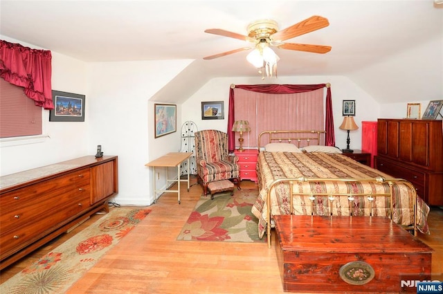 bedroom featuring lofted ceiling, ceiling fan, and wood finished floors