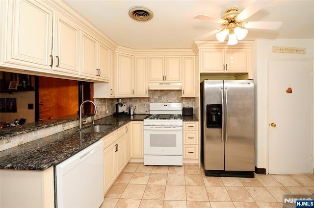 kitchen with white appliances, visible vents, a sink, under cabinet range hood, and backsplash