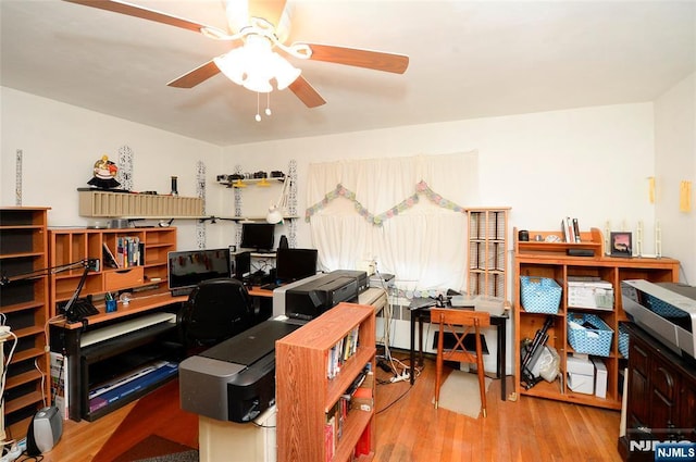 home office featuring wood finished floors and a ceiling fan