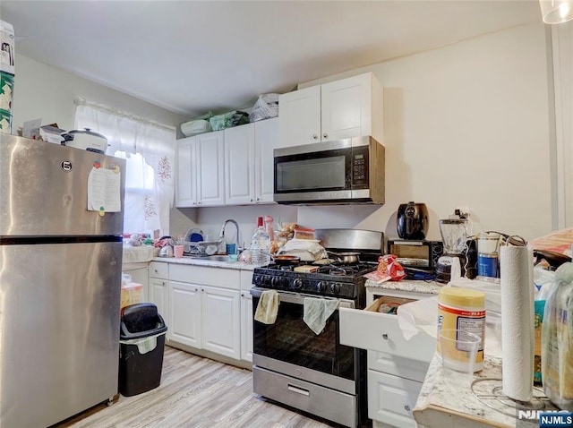 5 Elm St, Newark, NJ 07102 - kitchen featuring stainless steel appliances, a sink, light countertops, and light wood-style floors