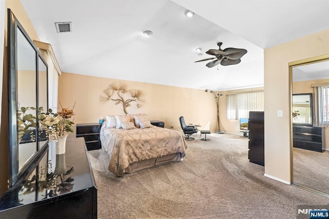 carpeted bedroom with ceiling fan, baseboards, visible vents, and vaulted ceiling