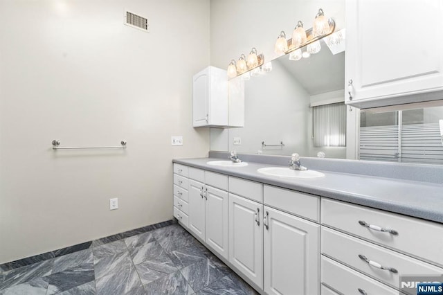 full bathroom with marble finish floor, double vanity, a sink, and visible vents