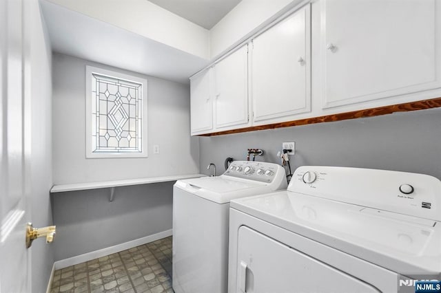 laundry area featuring cabinet space, tile patterned floors, baseboards, and independent washer and dryer