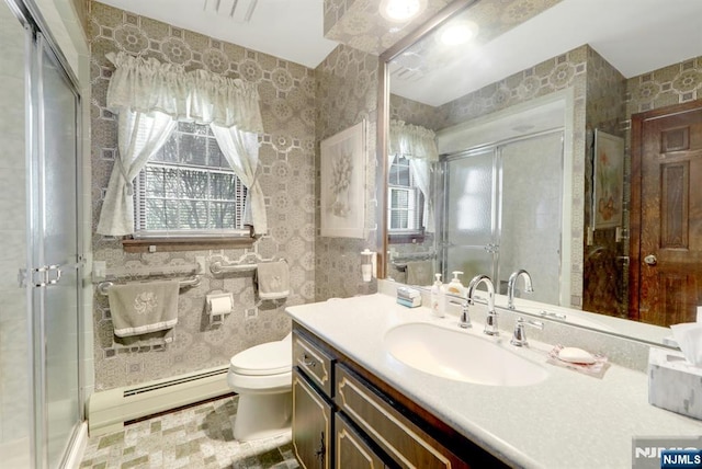 bathroom featuring a wealth of natural light, baseboard heating, and a shower stall