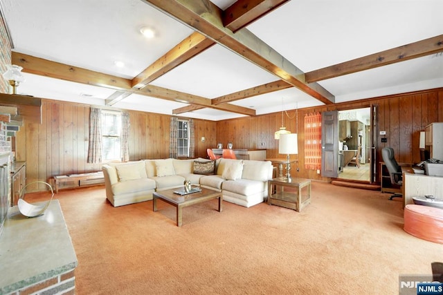 living room with beam ceiling, wooden walls, and carpet flooring