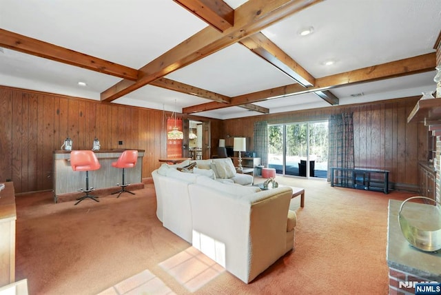 living area with beam ceiling, wood walls, a bar, and carpet