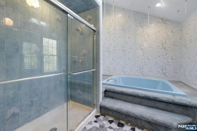 bathroom featuring a stall shower, wallpapered walls, and a garden tub