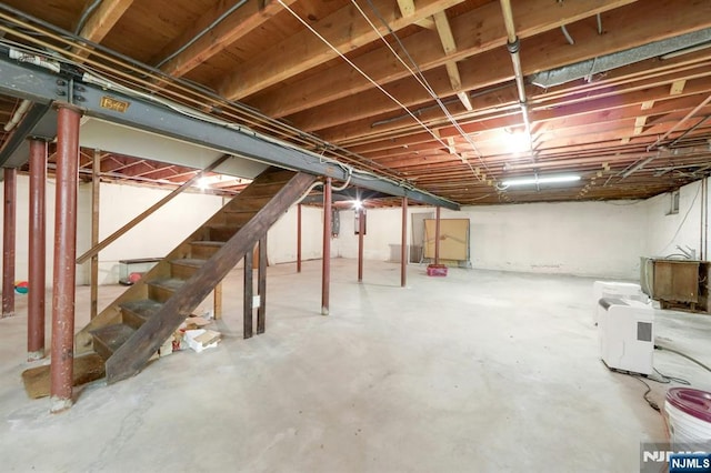 unfinished basement featuring stairs