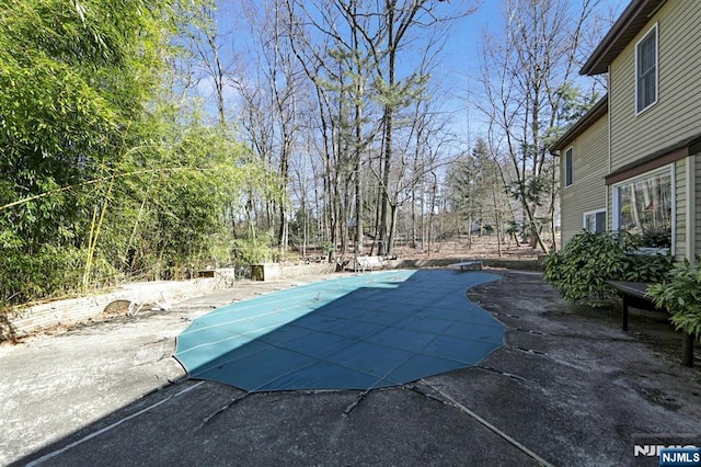 view of pool featuring a covered pool and a patio