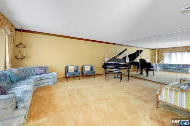 carpeted living room with visible vents and ornamental molding