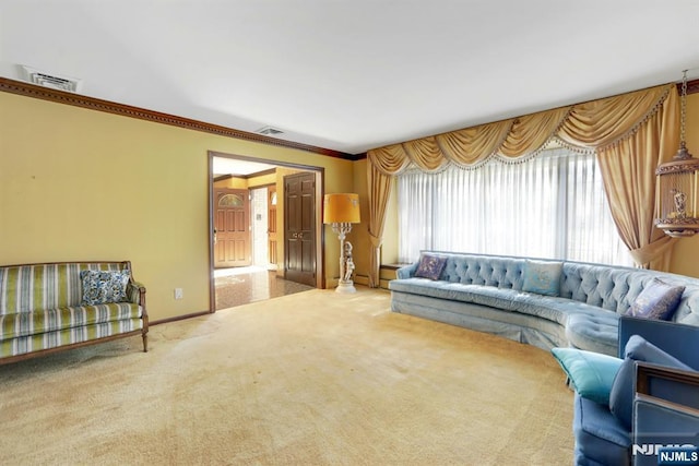 living area featuring visible vents, carpet flooring, baseboards, and ornamental molding