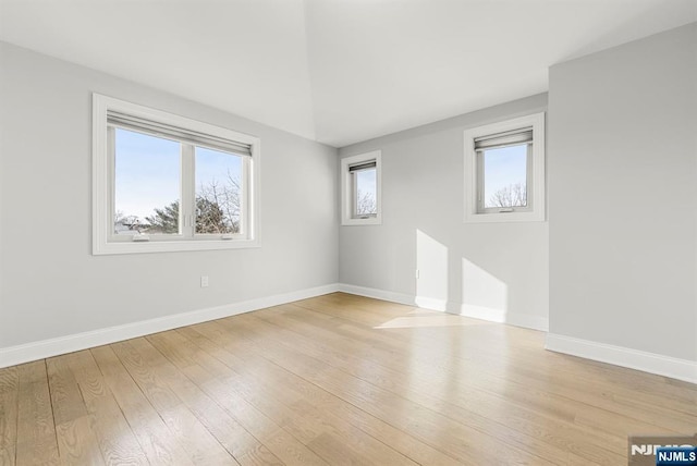 unfurnished room featuring light wood-style floors and baseboards