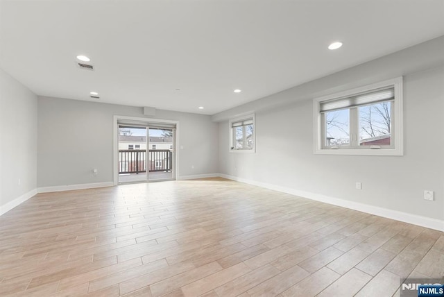 unfurnished room featuring baseboards, recessed lighting, visible vents, and light wood-style floors