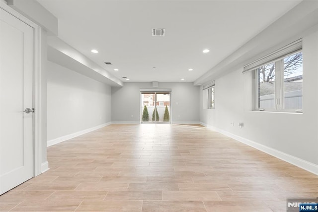 unfurnished room featuring light wood-type flooring, recessed lighting, visible vents, and baseboards