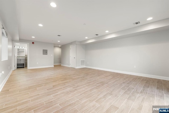 interior space with light wood finished floors, baseboards, visible vents, and recessed lighting