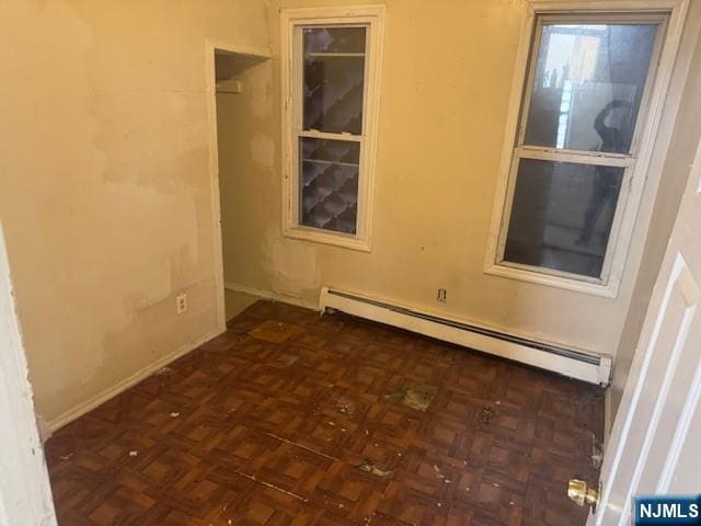 empty room featuring a baseboard radiator