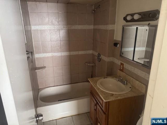 bathroom featuring shower / bath combination, vanity, and tile patterned floors