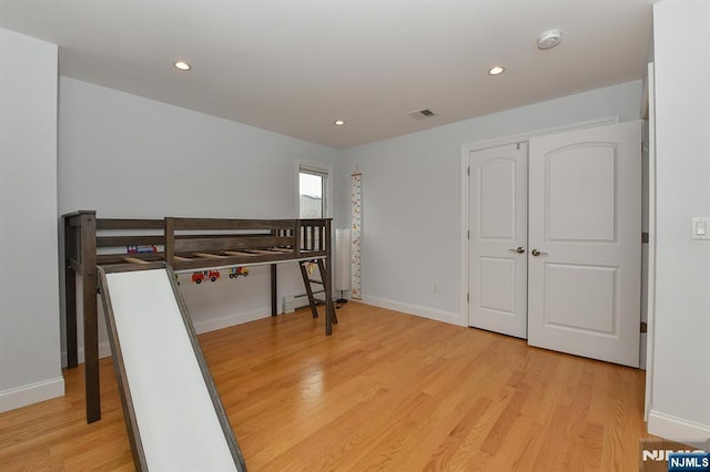bedroom with recessed lighting, light wood-style floors, visible vents, and baseboards