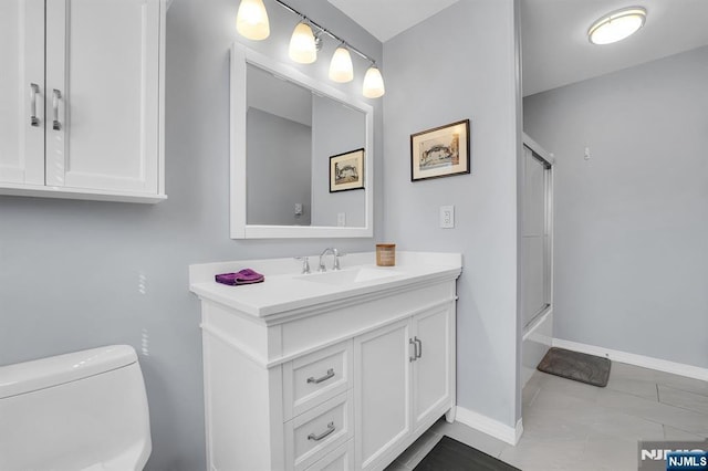 full bath with baseboards, vanity, and toilet