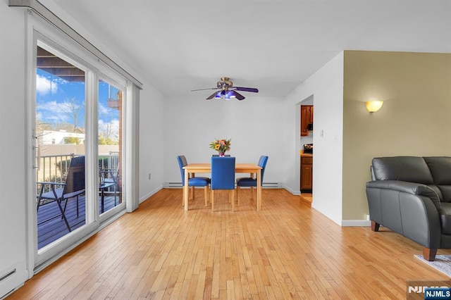 dining area featuring light wood-style floors, a baseboard radiator, baseboards, and a ceiling fan