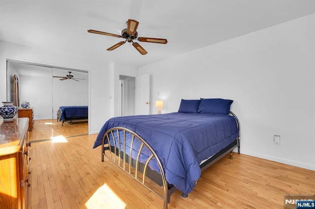 bedroom featuring baseboards, ceiling fan, a closet, and light wood-style floors