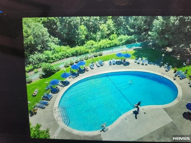 pool featuring a patio area and fence