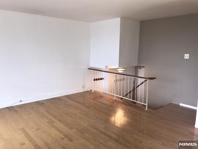 unfurnished room with wood finished floors