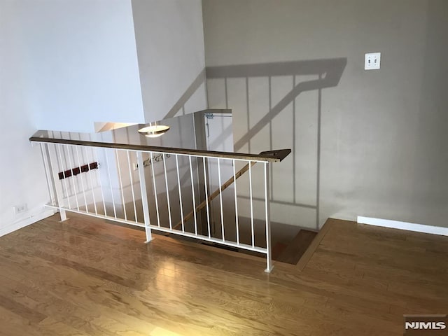 staircase featuring wood finished floors