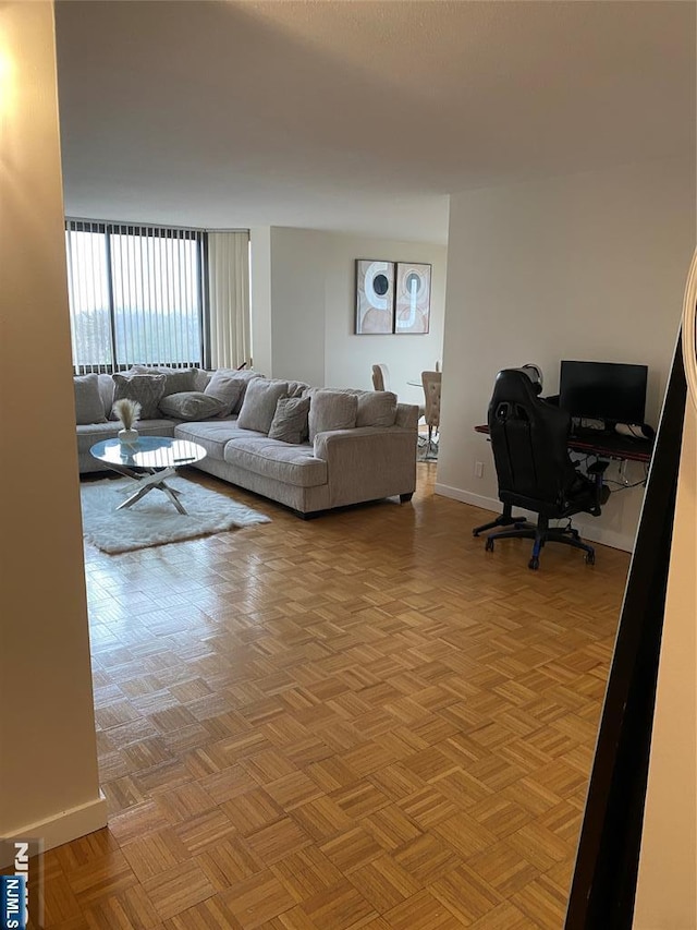 living area featuring baseboards