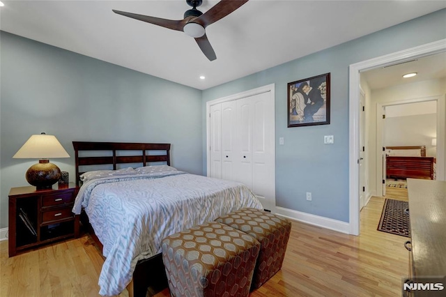 bedroom with light wood-style floors, baseboards, a closet, and ceiling fan