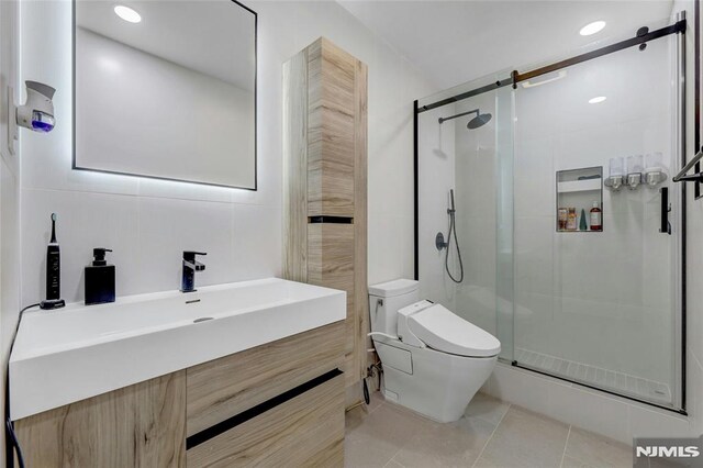 full bathroom with tile patterned floors, toilet, a stall shower, and vanity